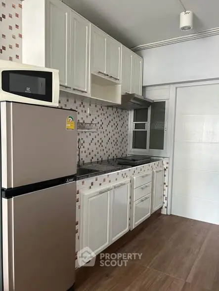 Modern kitchen with sleek appliances and stylish cabinetry in a contemporary home.