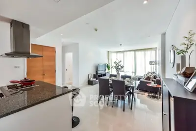 Spacious open-plan living room with modern kitchen and elegant decor