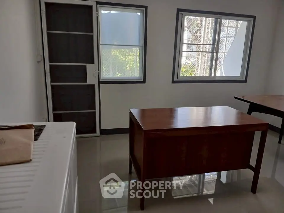 Bright study room with modern desk and large windows in a contemporary home.