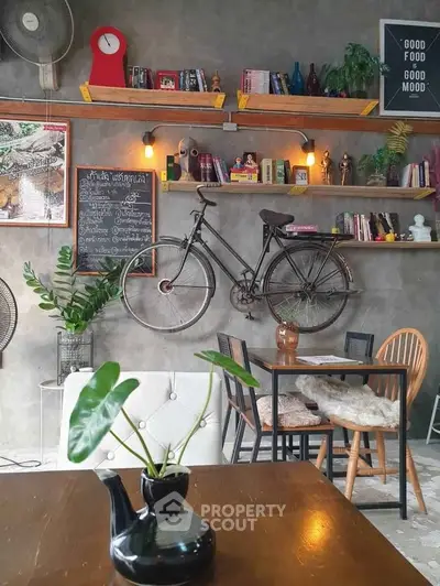 Charming cafe-style living room with vintage bicycle decor and cozy seating.