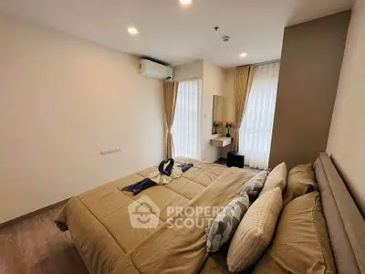 Modern bedroom with stylish decor and natural light in a contemporary apartment.