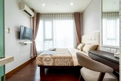 Modern bedroom with large window, stylish decor, and wall-mounted TV in a high-rise apartment.