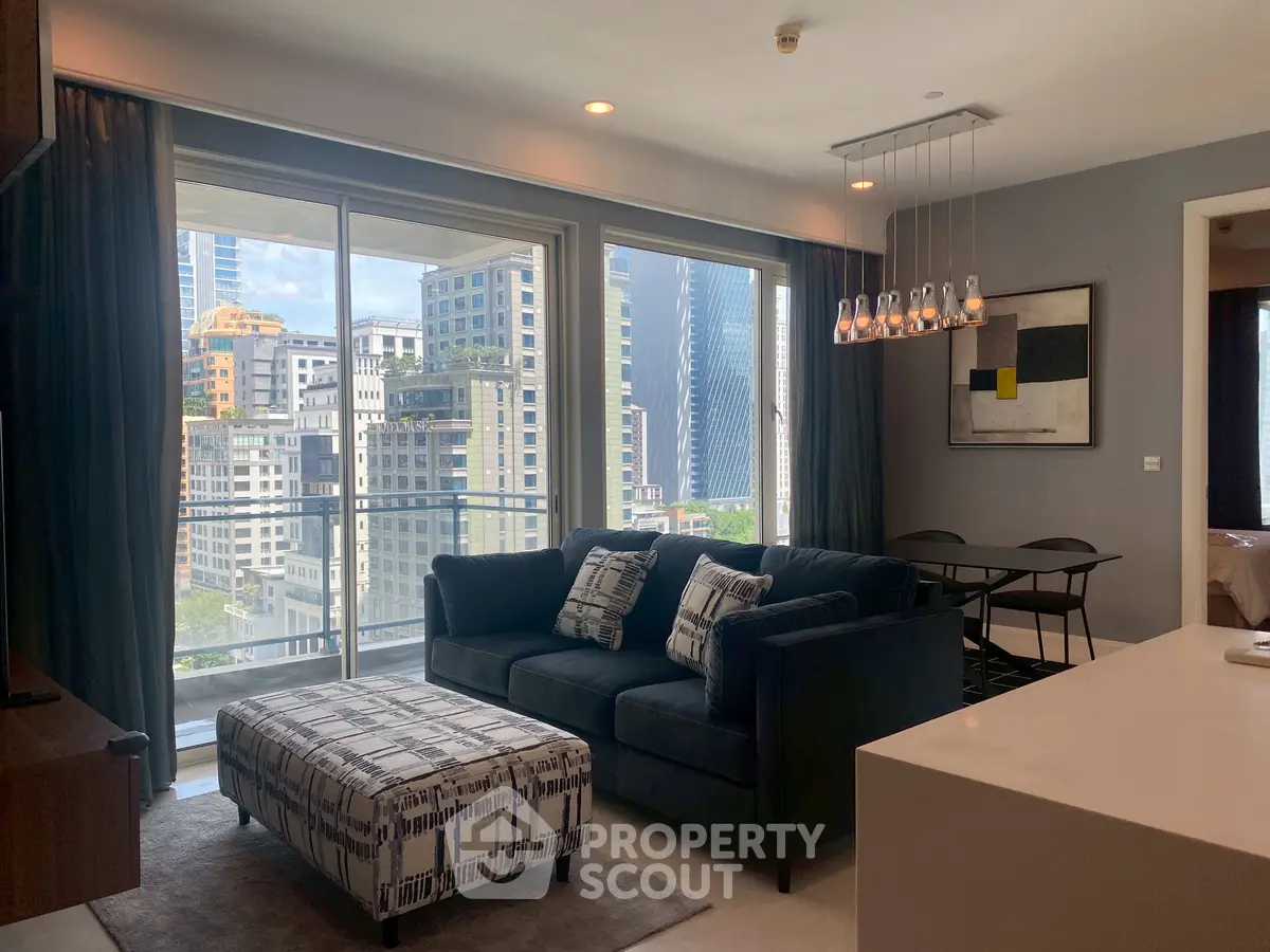 Modern living room with city view, stylish furniture, and elegant lighting in a high-rise apartment.