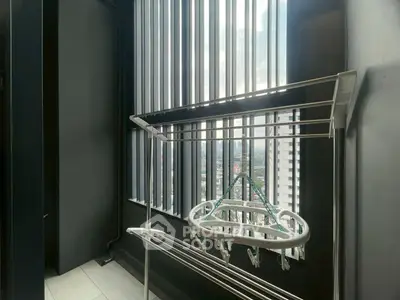 Modern balcony with city view and drying rack, perfect for urban living.