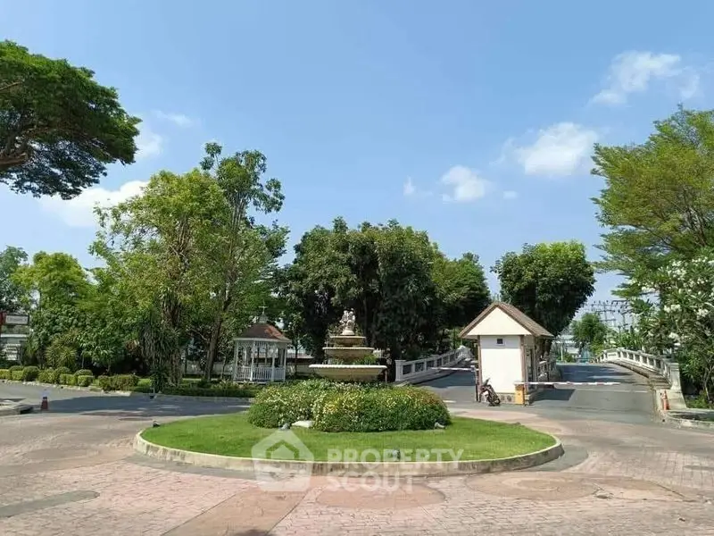 Charming residential entrance with lush greenery and serene surroundings.