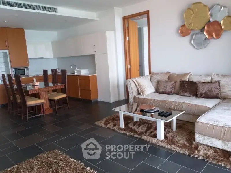 Spacious open-plan living room with modern kitchen and cozy seating area.