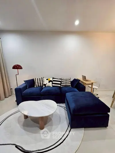 Modern living room with blue sofa, stylish coffee table, and chic decor