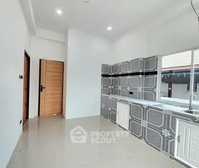 Modern kitchen with sleek tile design and ample natural light