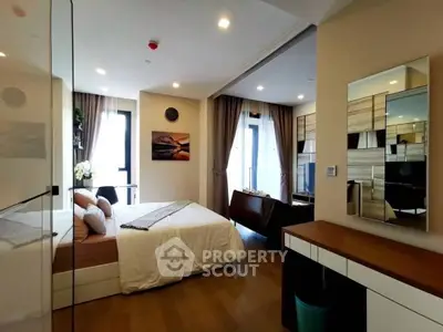 Modern bedroom with stylish decor and natural light, featuring a cozy bed and elegant furnishings.