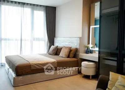 Modern bedroom with large window and stylish decor