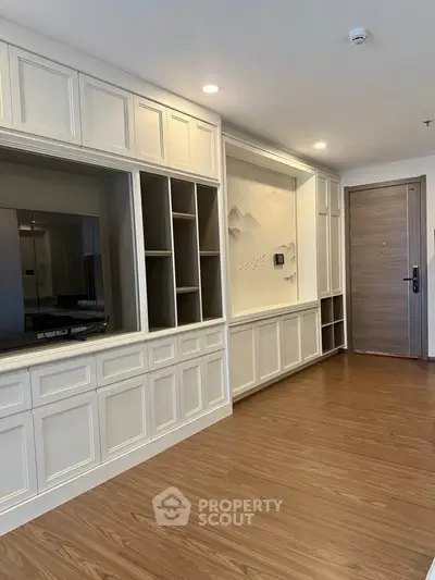 Elegant living room with built-in shelving and wood flooring