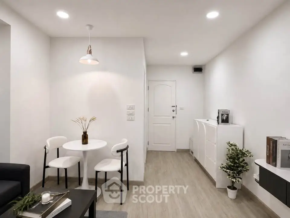 Modern minimalist living room with white walls, sleek furniture, and stylish decor.
