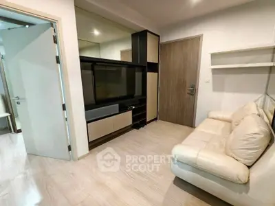 Modern living room with sleek furniture and wooden flooring in a cozy apartment.