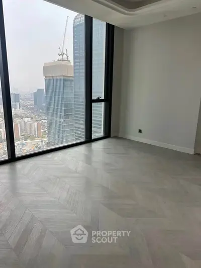 Luxurious high-rise apartment with stunning city view and elegant flooring.