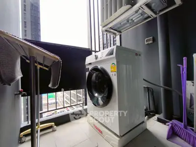 Modern apartment balcony with washing machine and city view