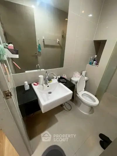 Modern bathroom with sleek fixtures and ample storage space.