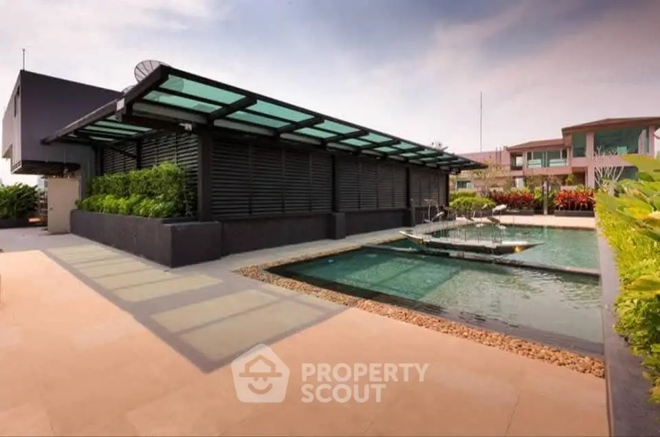 Luxurious rooftop pool with modern design and lush greenery, perfect for relaxation and leisure.