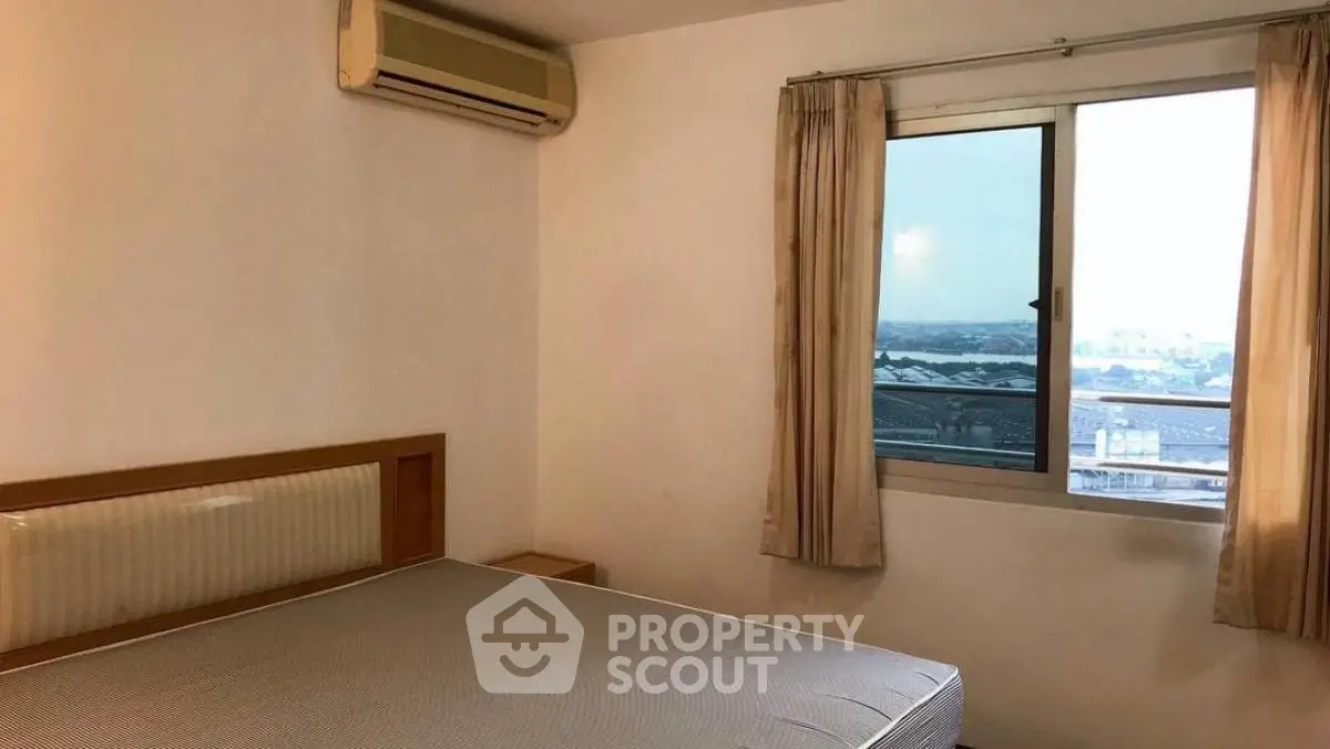 Cozy bedroom with air conditioning and window view in modern apartment.
