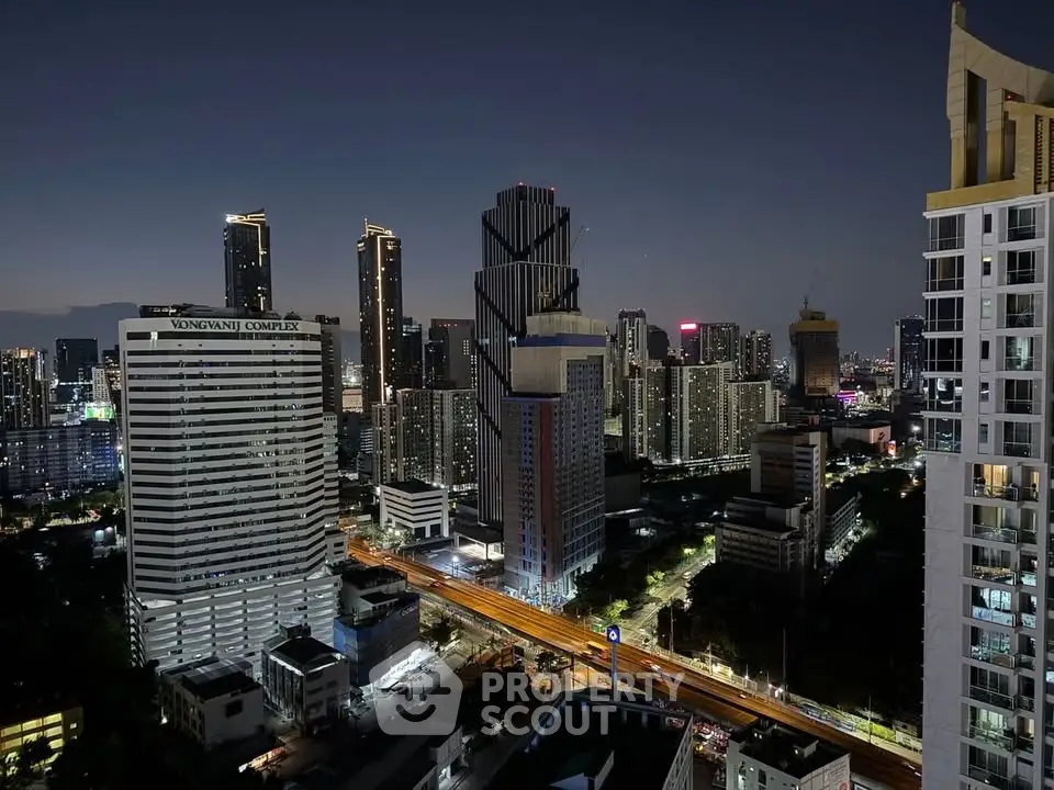 Stunning cityscape view of modern skyscrapers at night with vibrant city lights.