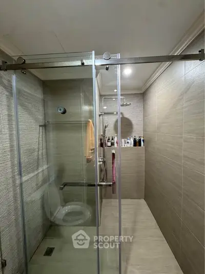 Modern bathroom with glass shower enclosure and sleek tile design