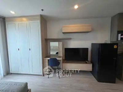 Modern living room with sleek furniture and built-in storage in a stylish apartment.