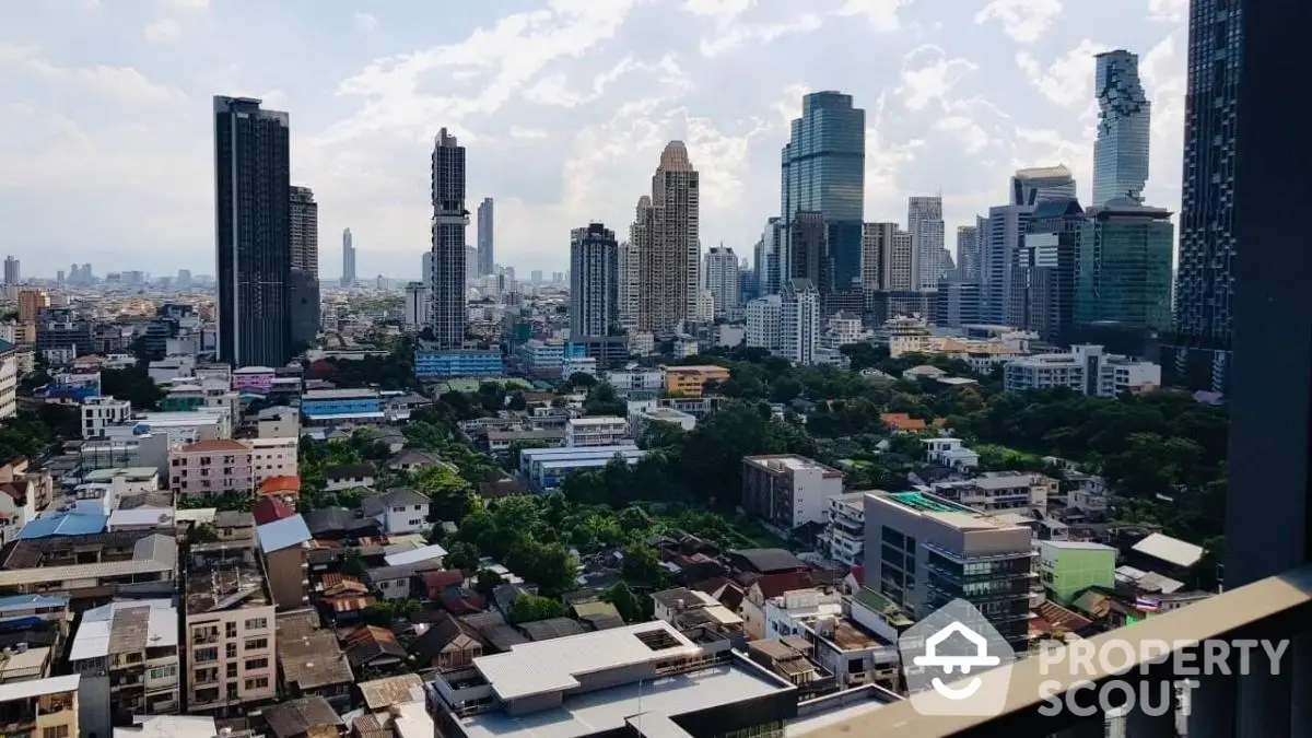 Stunning cityscape view from a high-rise balcony showcasing urban skyline and lush greenery.