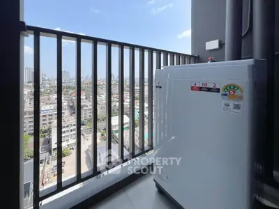 High-rise balcony with city view and outdoor appliance, perfect for urban living.