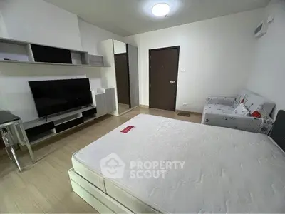 Modern bedroom with sleek furniture and large TV, perfect for comfortable living.