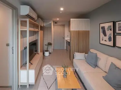 Modern living room with stylish decor and open layout, featuring cozy seating and contemporary artwork.