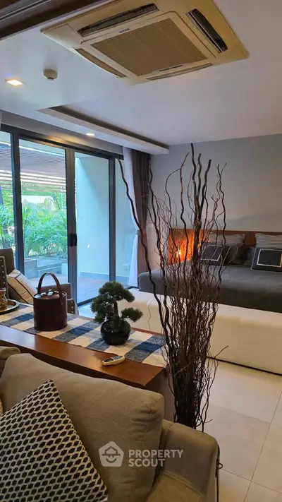Luxurious living room with modern decor and garden view, featuring elegant furniture and stylish accents.