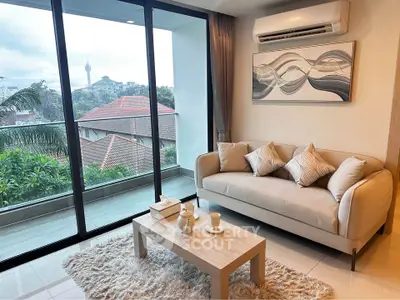 Modern living room with cozy sofa and balcony view in urban apartment