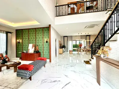 Luxurious open-plan living area with elegant staircase and stylish decor