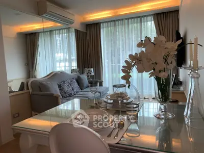 Elegant living room with modern decor, large windows, and stylish dining setup in a cozy apartment.
