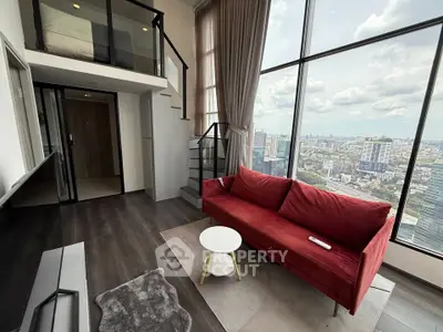 Modern loft apartment with stunning city view and stylish red sofa