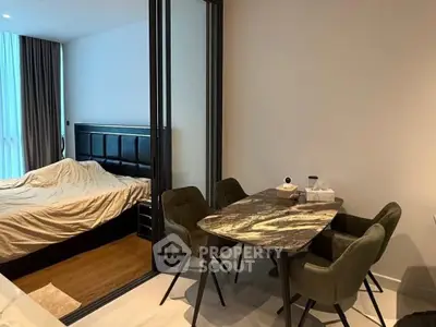 Modern studio apartment with stylish dining area and cozy bedroom