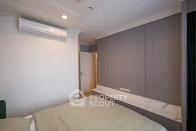 Modern bedroom with elegant paneling and air conditioning, showcasing luxury living.