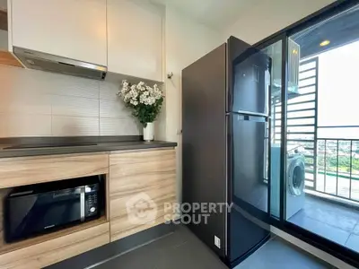 Modern kitchen with sleek appliances and balcony view