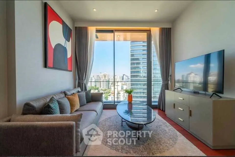 Modern living room with large window offering stunning city view, stylish decor, and comfortable seating.