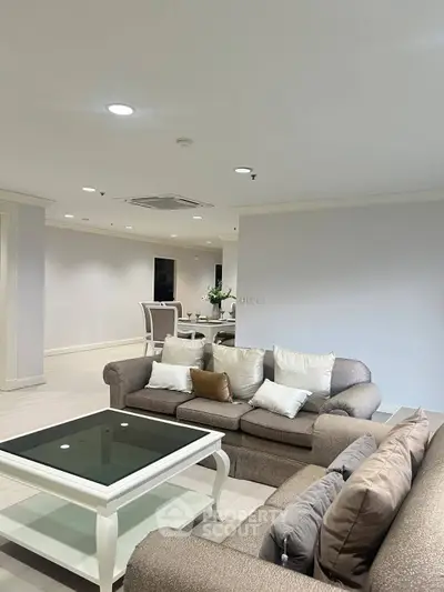 Spacious living room with elegant furniture and modern decor in a luxurious apartment.