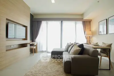 Modern living room with cozy sofa, large window, and stylish decor in a bright apartment.