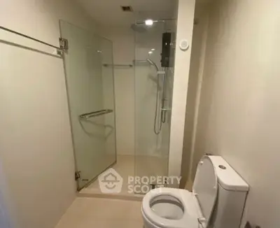 Modern bathroom with glass shower enclosure and sleek toilet design
