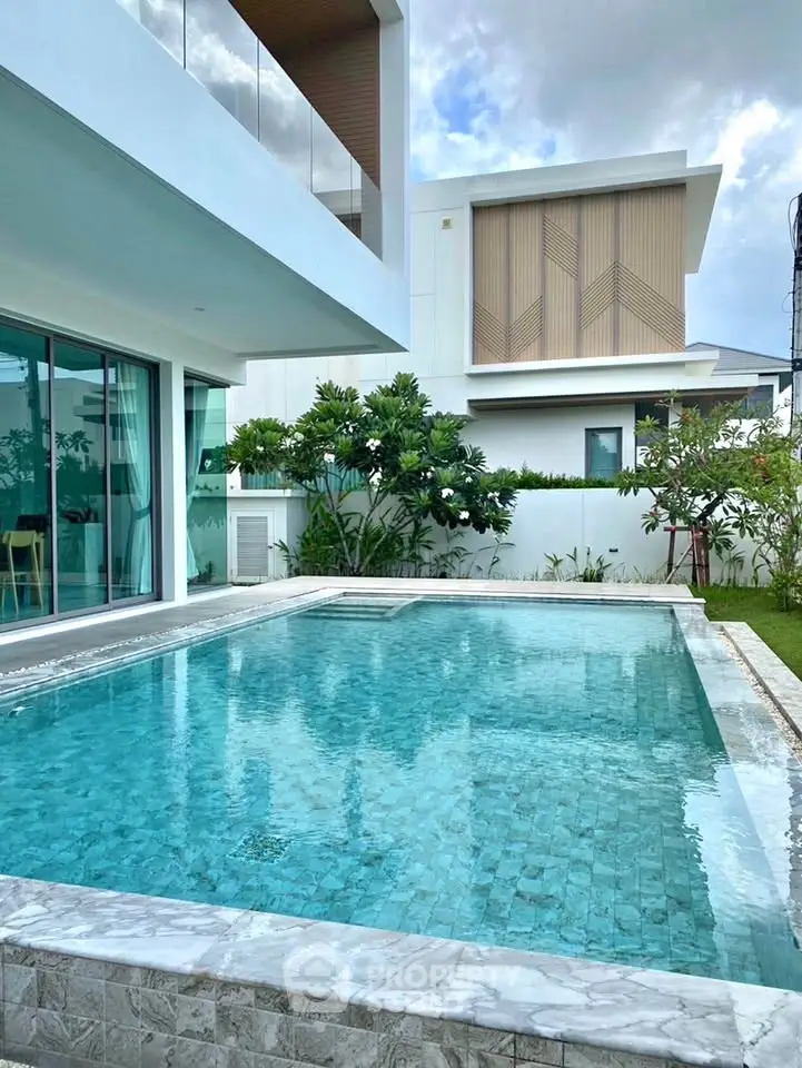 Luxurious modern home with private pool and lush garden, perfect for relaxation and entertaining.