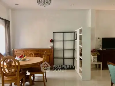 Spacious dining area with elegant wooden furniture and modern shelving unit