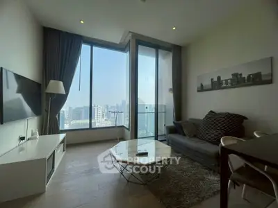 Modern living room with stunning city view, featuring sleek furniture and floor-to-ceiling windows.