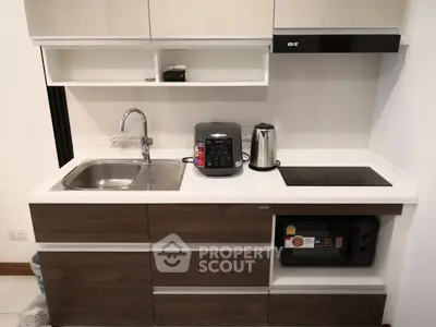 Modern compact kitchen with sleek cabinetry and appliances