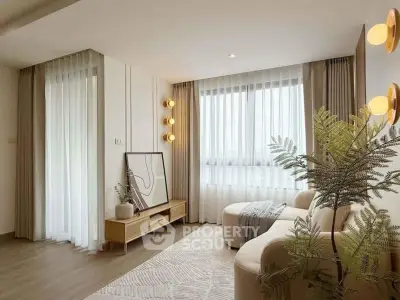 Modern living room with elegant decor, featuring a cozy sofa, stylish lighting, and large windows with sheer curtains.