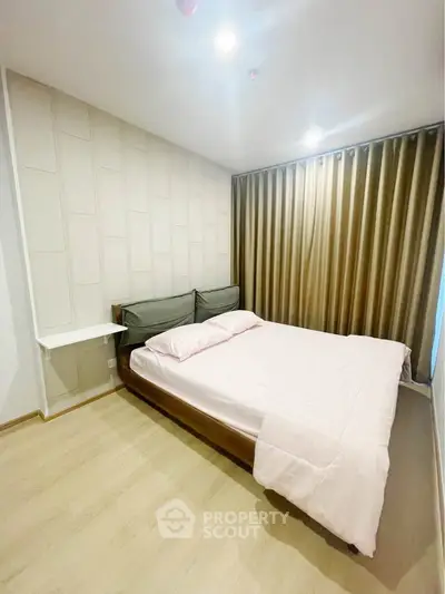 Modern bedroom with stylish decor and cozy ambiance, featuring a comfortable bed and elegant curtains.