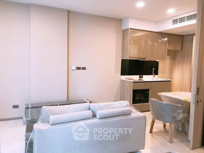 Modern living room with compact kitchen in a stylish apartment