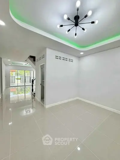 Modern interior with sleek lighting and glossy tile flooring in a spacious living area.