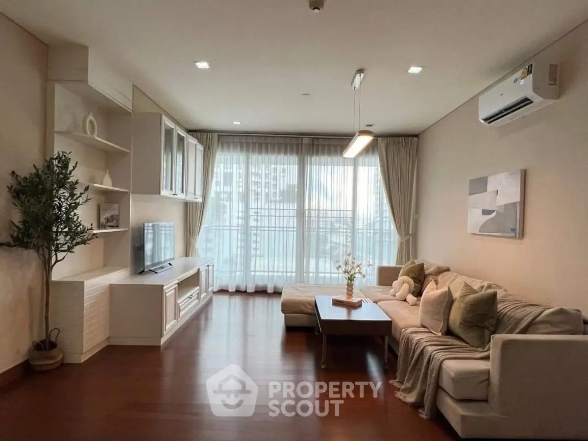Spacious modern living room with large windows and elegant decor
